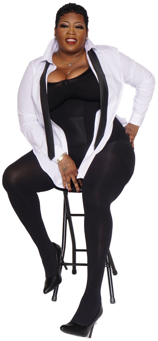 Ro, owner of DiVine Stylez, seated in a white tuxedo shirt and black tie