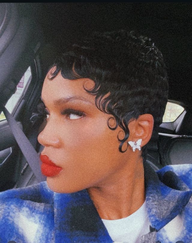 Short quick weave, sculpted finger waves with a bold red lip
